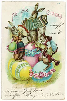 Three musical hares on three decorated Easter eggs