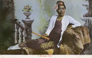 Images Dated 11th August 2015: Myanmar - A Burmese girl reclining on a studio divan
