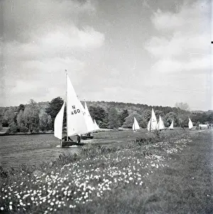 National 12 sailing dinghies on a Devon river
