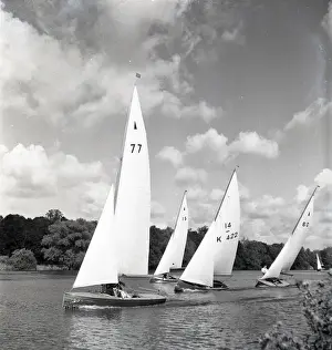 National 12 sailing dinghies on a Devon river