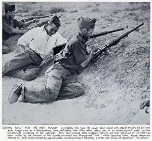 Recruits Collection: Two Nationalist volunteers reloading their rifles as they fire at a Republican position near San