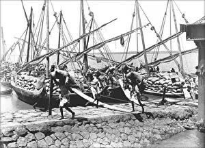 Natives unloading cargo from boats