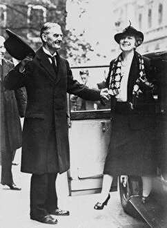 Neville Chamberlain helping his wife out of a car