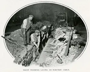Night workers laying an electric cable in London 1900