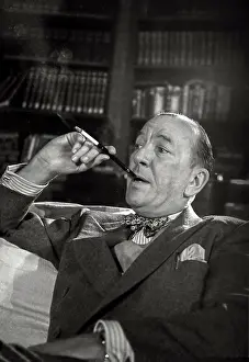 Relative Prints: Noel Coward sits with cigarette in holder during rehearsal of Relative Values which opened at The Savoy Theatre