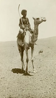 Climate Prints: A nomad riding a camel in the desert
