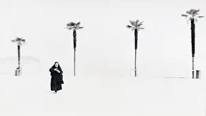 Nun with background of four palm trees