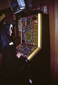 Gambler Prints: Nun playing on a fruit machine
