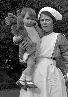 Nurse with toddler and teddy bear