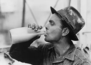Oil field worker drinking a bottle of milk at lunch, Kilgore