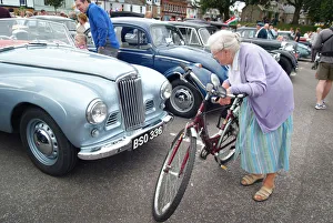 Images Dated 8th August 2019: An old lady stops to look closely at a vintage motor car