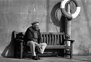 Images Dated 8th August 2019: An old man on a bench in the harbour at Ramsey, Isle of Man