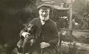 Cardigan Gallery: Old man with dog in garden