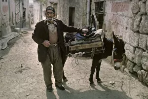 Anatolia Gallery: An old man with a donkey in a back street of Avanos