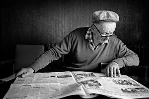 Images Dated 13th June 2019: Old man reading newspaper in cafe, Le Monastier-sur-Gazeille