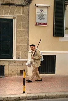 Menorca Gallery: An old man walks down a street in Menorca, Spain