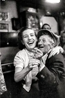 Older slight man dancing with young woman to small band playing in daylight at local bar at Cafe In de Ton de Koninck in Katten Straat Antwerp-both very happy Date: circa 1951