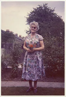 Images Dated 4th February 2021: An older visually-impared woman in a neat suburban garden