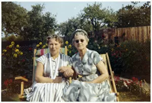 Images Dated 4th February 2021: Two older women sitting arm-in-arm in garden chairs