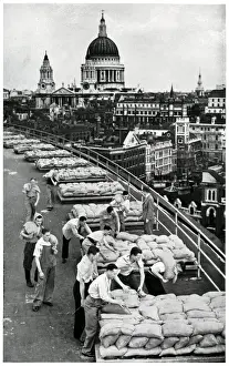 Sandbags Prints: Outbreak of WWII Sandbagging flat roof of an office building