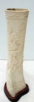 Pair of carved bone ornaments with raised foliate decoration