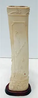 Pair of carved bone ornaments with raised foliate decoration