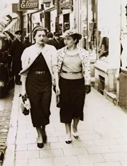 A pair of rich girls off shopping - passing an Etam Store