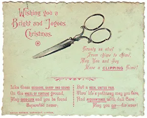 Pair of scissors with comic verse on a Christmas card