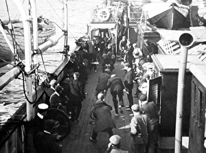 Passengers playing deck games, tug of war, on ship