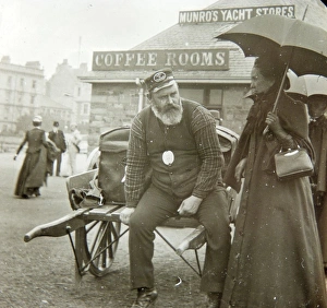 Munro Gallery: Passengers with porter, waiting to board a boat