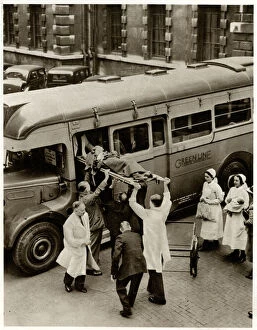 Ambulances Gallery: Patient on stretcher lifted onto evacuation coach 1939