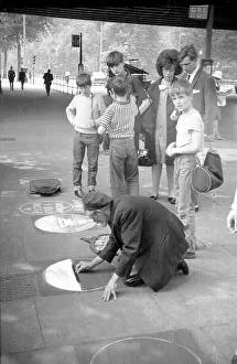 Hungerford Prints: A pavement artist under Hungerford Bridge