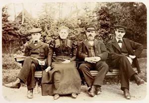 Four people on a bench in a garden