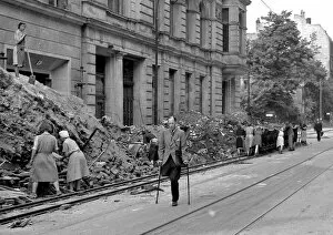Piles Gallery: People in a bomb damaged street during WW2