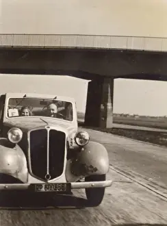 Two people in a car on the Autobahn, Germany