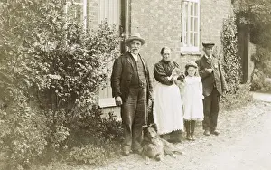 Four people, a cat and a dog in a garden