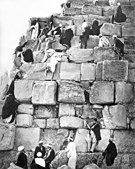 People climbing a pyramid, Egypt