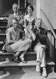 Four people with collie dog