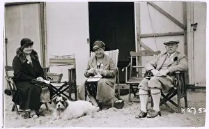 Three people and a dog on the beach