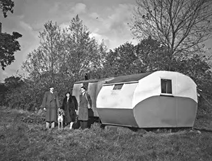Caravans Prints: People and dog in a field next to two caravans