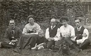 Six people and two dogs in a garden