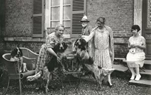 Knitting Gallery: People with three dogs in a garden, France