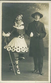 Two people in fancy dress. The girl on the left is in a fanciful Pierrot type outfit