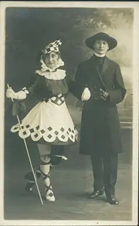 Vicar Prints: Two people in fancy dress. The girl on the left is in a fanciful Pierrot type outfit