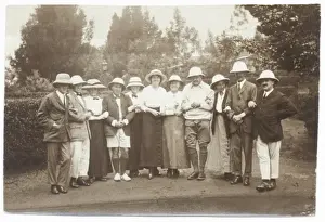 Linked Prints: Eleven people in a garden wearing pith helmets