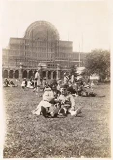 People on the grass in front of the Crystal Palace, London