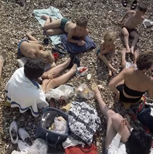 Tomato Collection: People having a picnic on a pebbly beach