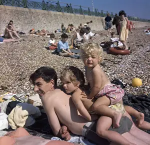 Pebbly Prints: People on holiday on a pebbly beach