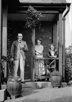 Three people outside a house