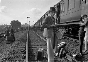 Stopped Prints: People on a railway track alongside a train